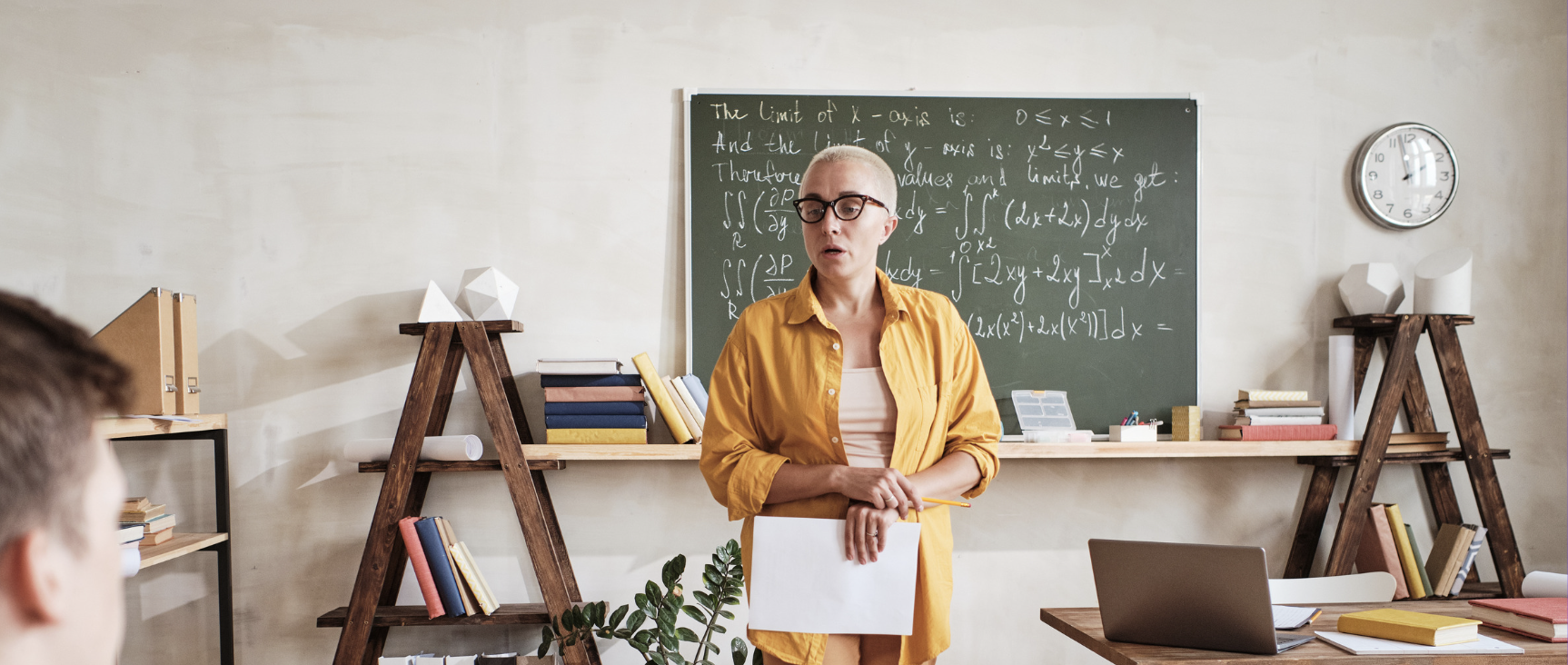 Teacher standing at front of classroom presenting a lesson